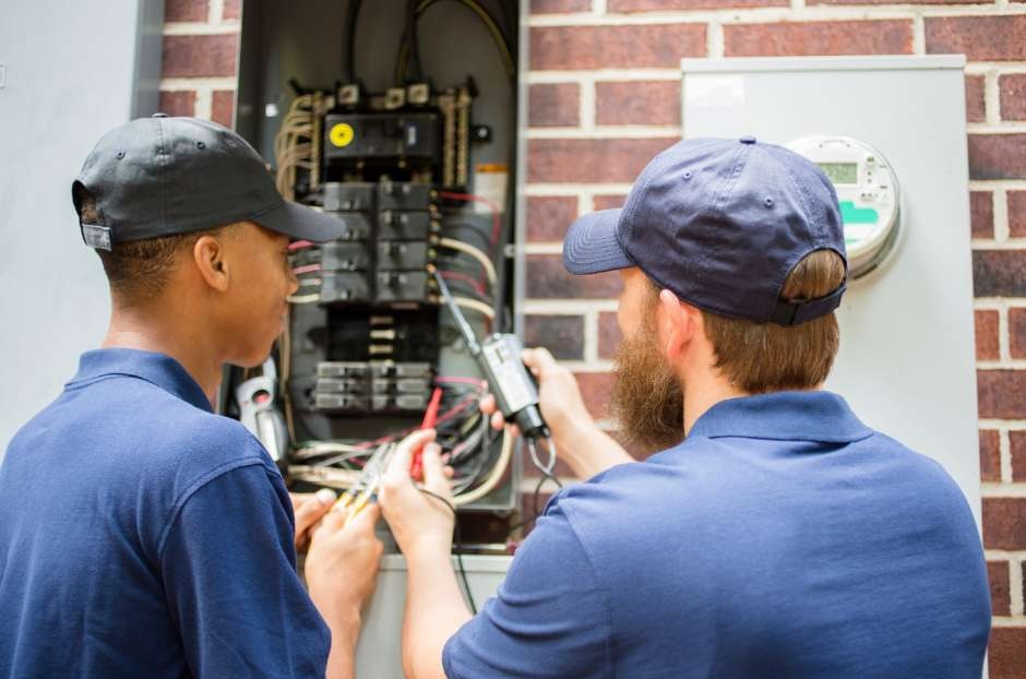 Electrician inspecting electrical panel in Minnesota spring