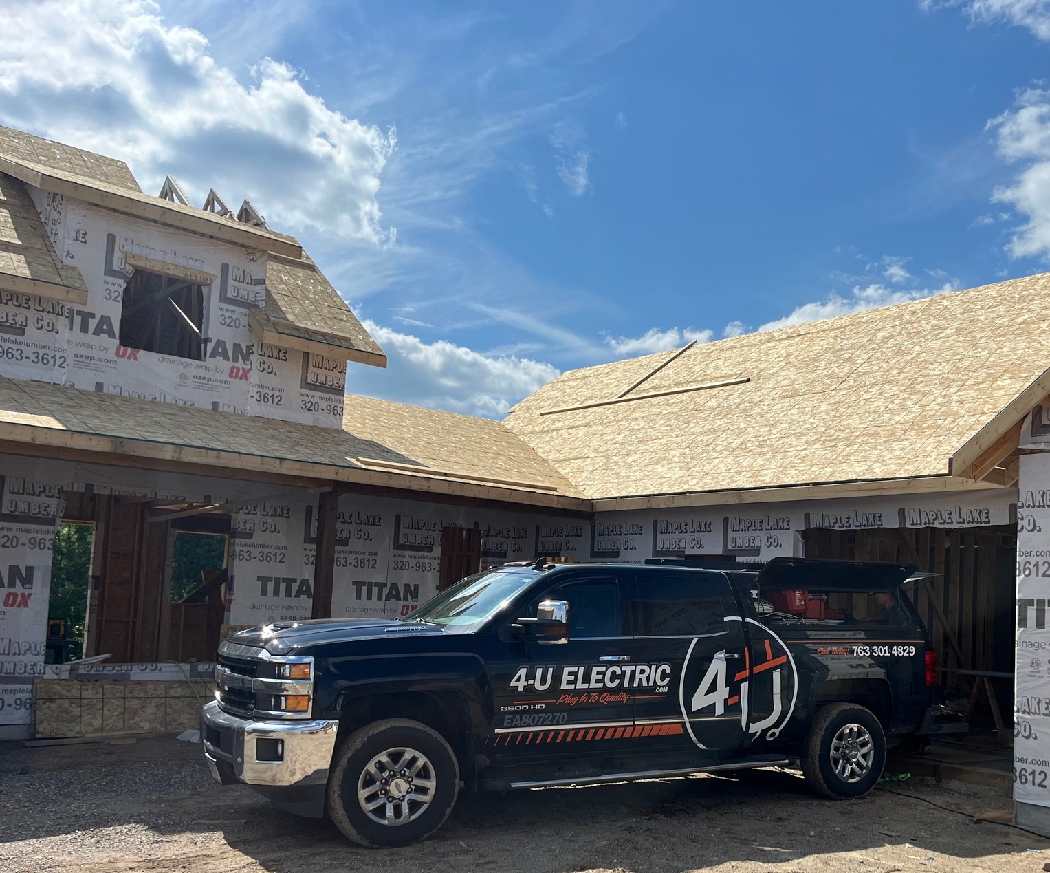 Licensed electrician working on a residential electrical panel in a Minnesota home